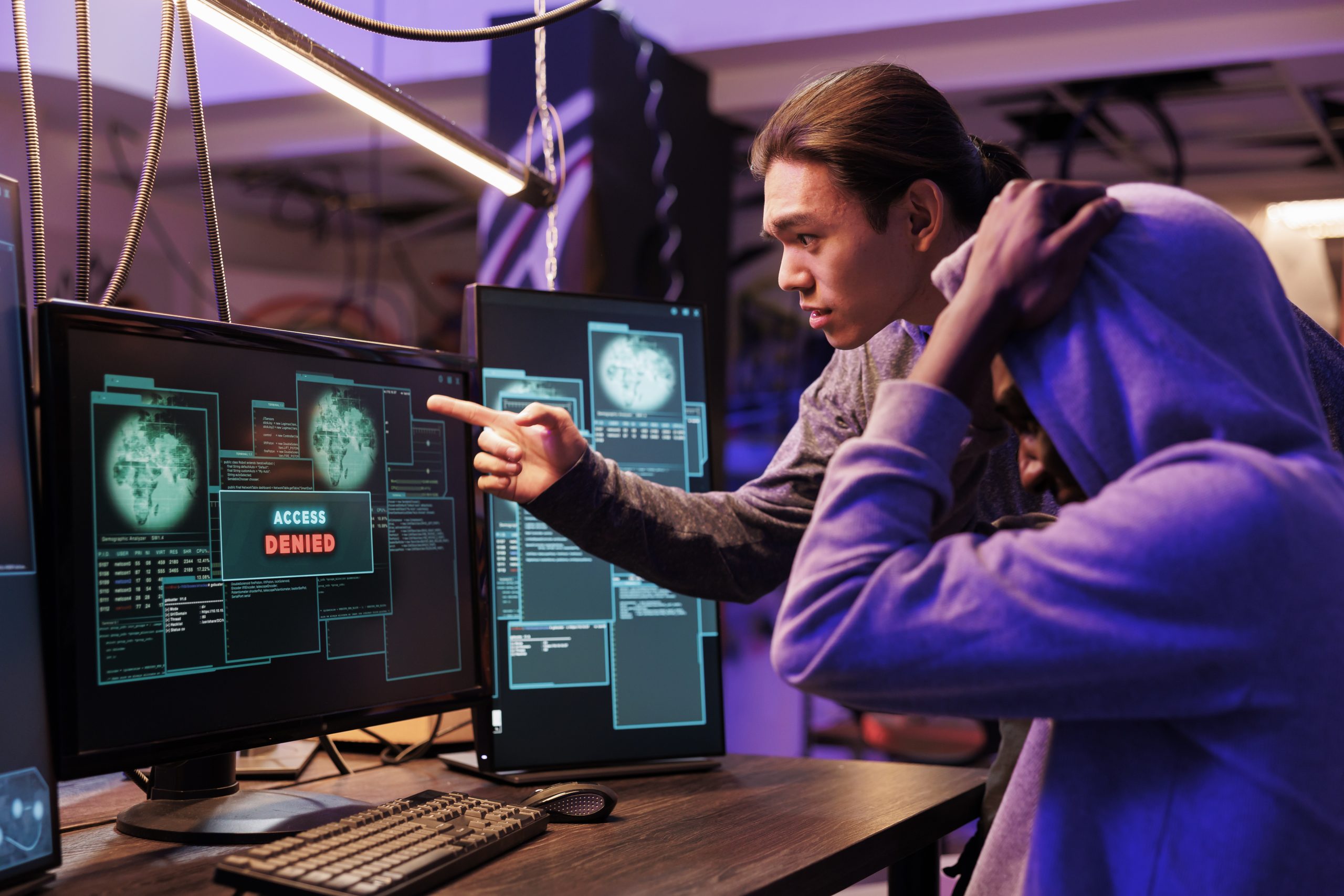 Unhappy hackers failing to crack password while breaking into computer network. Two disappointed criminals getting access denied while hacking website and attempting to pass security system