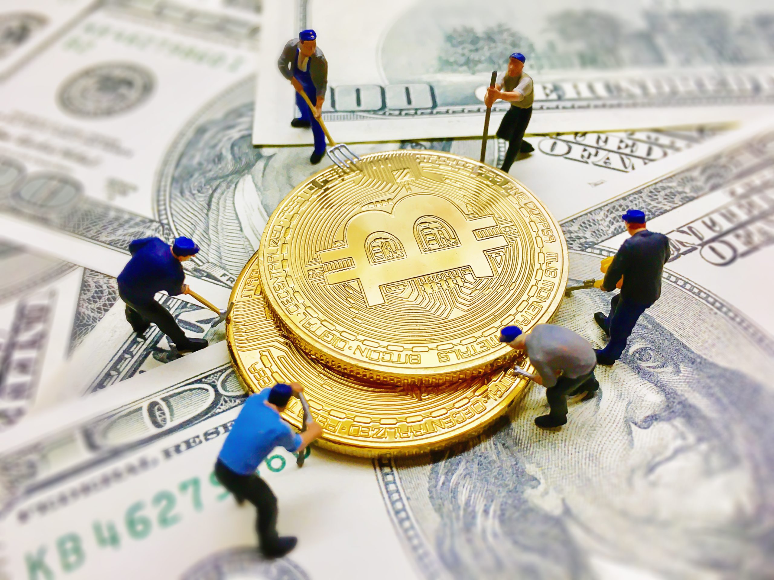 Worker figures helping dig coin money on dollar note background - worker figures model with money seeking business concept